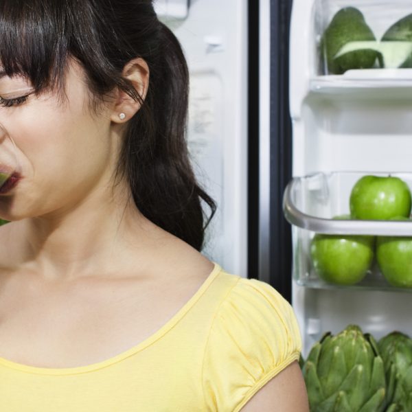 Girl frowning and drinking nasty green smoothie