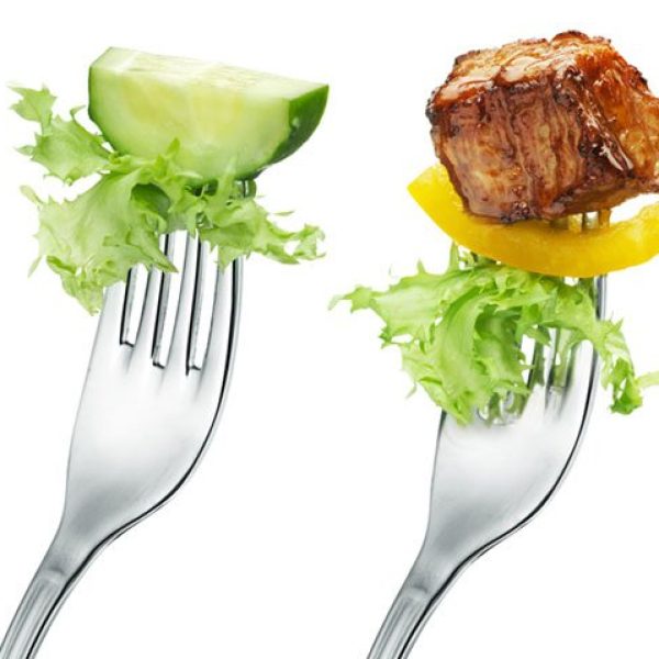 A fork with only vegetables and a fork with vegetables and meat